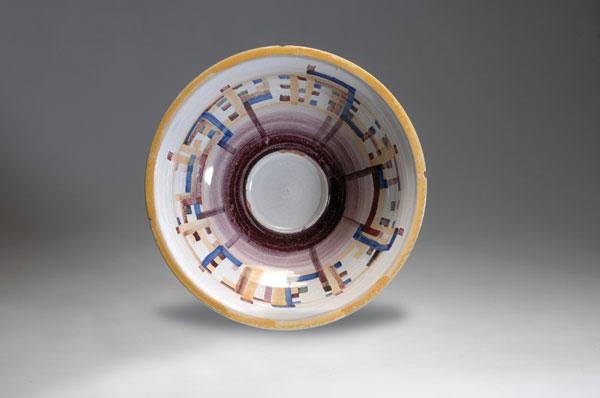 Werner Burri. Bowl, designed c. 1928. H. 9.2 cm; Di: Werner Burri. Bowl, designed c. 1928. H. 9.2 cm; Diameter 29.8 cm. Made by Steingutfabriken Velten-Vordamm, prior to 1931. Majolica, glazed yellow, blue and purple on white. Marked: Artist's signet.