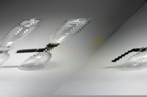 Marcks, Gerhard; Mauder, Bruno; Wagenfeld, Wilhel: Gerhard Marcks; Bruno Mauder; Wilhelm Wagenfeld. Pair of 'Sintrax' coffee makers, designed in 1932 resp. 1949. H. 24 cm resp. 24.6 cm. Made by Jenaer Glas Schott & Gen., Jena and Mainz. Clear glass, h