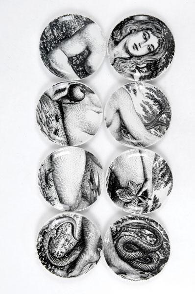 Fornasetti, Piero: Piero Fornasetti. Eight 'Eva' coasters, designed circa 1965. Diameter 10.5 cm. Made by Fornasetti, Milan, in 1965. Porcelain, white, glazed, overglaze in black. Marked: EVA, ADAMO ED EVA copyright PIE