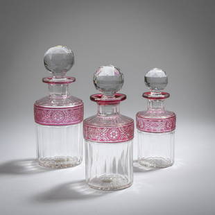 Cristallerie de Baccarat, Paris, 3 flacons, 1920s: Cristallerie de Baccarat, Paris, 3 flacons, 1920s, H. 14-17 cm. Crystal glass, colorless and raspberry red. Cut decor. Sales label Nantes on 2 flacons.,