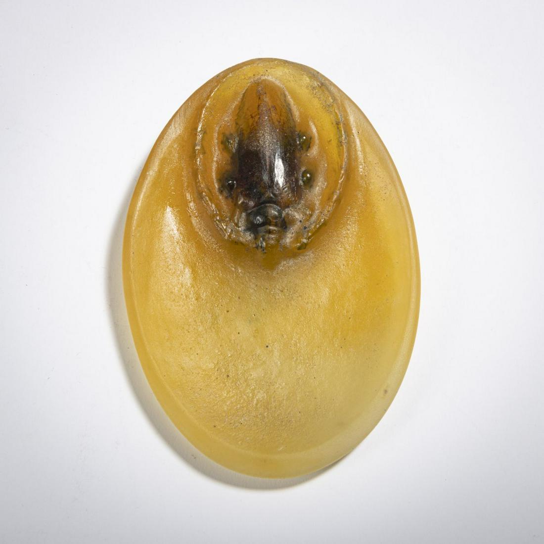 Henri Berge, Small 'Capricorne du Chène' dish, c. 1925: Henri Berge, Small 'Capricorne du Chène' dish, c. 1925, 11.8 x 8 cm. Pâte de verre, slightly translucent glass mass, molded, mainly amber. Relief depiction of an oak buck, black and brown