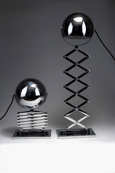 Dorothee Becker: Dorothee Becker. Two 'Scissor' lamps, designed in 1968. H. 88.5 cm (max.). Made by Design M, Ingo Maurer, Munich. Chrome-plated metal sheet. Marked: Maker's label.