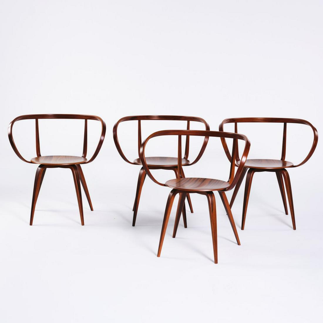 George Nelson, 4 'Pretzel chairs', 1952: George Nelson, 4 'Pretzel chairs', 1952, H. 73.5 x 67.5 x 47 cm. Made by Vitra Design, Weil/Rhine, in 2008. Walnut, walnut veneer. Marked: Metal badge George Nelson Pretzel Chair 1952. Anniversary Edi