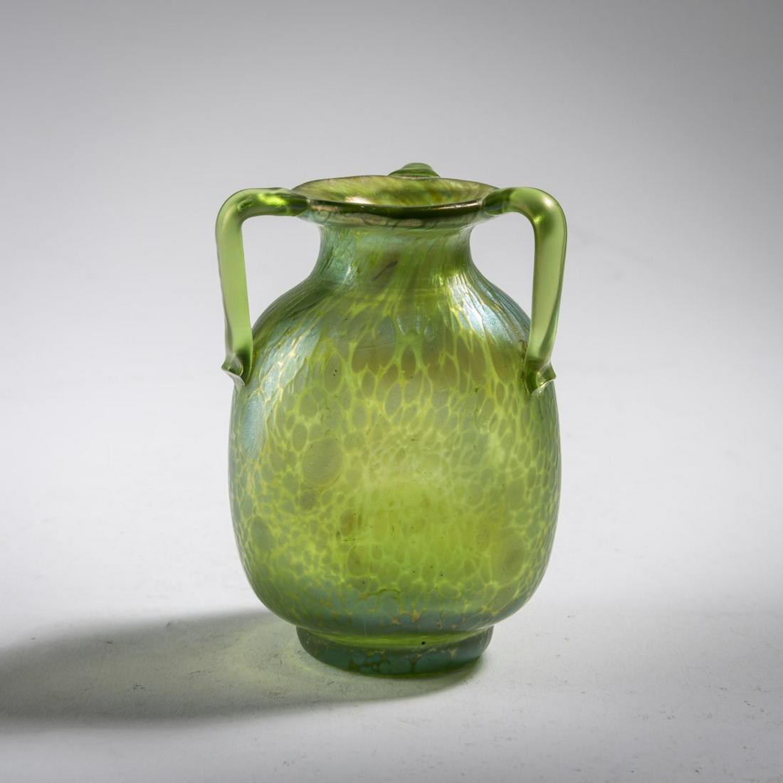 Loetz, Klášterský Mlýn, Miniature vase 'Papillon' with three handles, c.: Loetz, Klášterský Mlýn, Miniature vase 'Papillon' with three handles, c. 1900, H. 7.7 cm. Green glass, rolled-in crumbs in silvery yellow, creta papillon, pearlescent matt