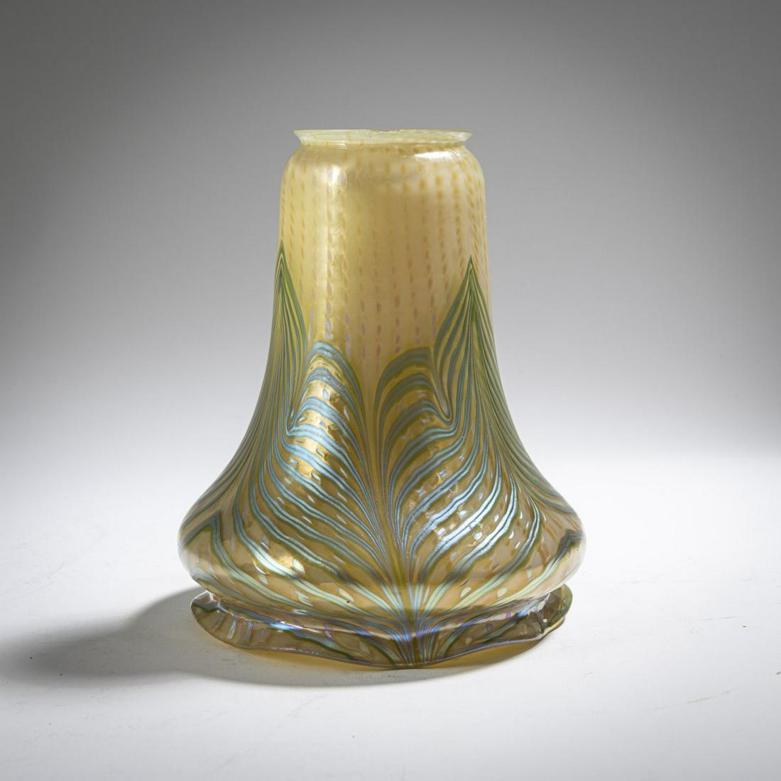 Loetz, Klášterský Mlýn, 'Phänomen' lamp shade, c. 1902: Loetz, Klášterský Mlýn, 'Phänomen' lamp shade, c. 1902, H. 16.8 cm. Cased glass, colorless and opal white, feather-like painted blue and silver-yellow thread decoratio