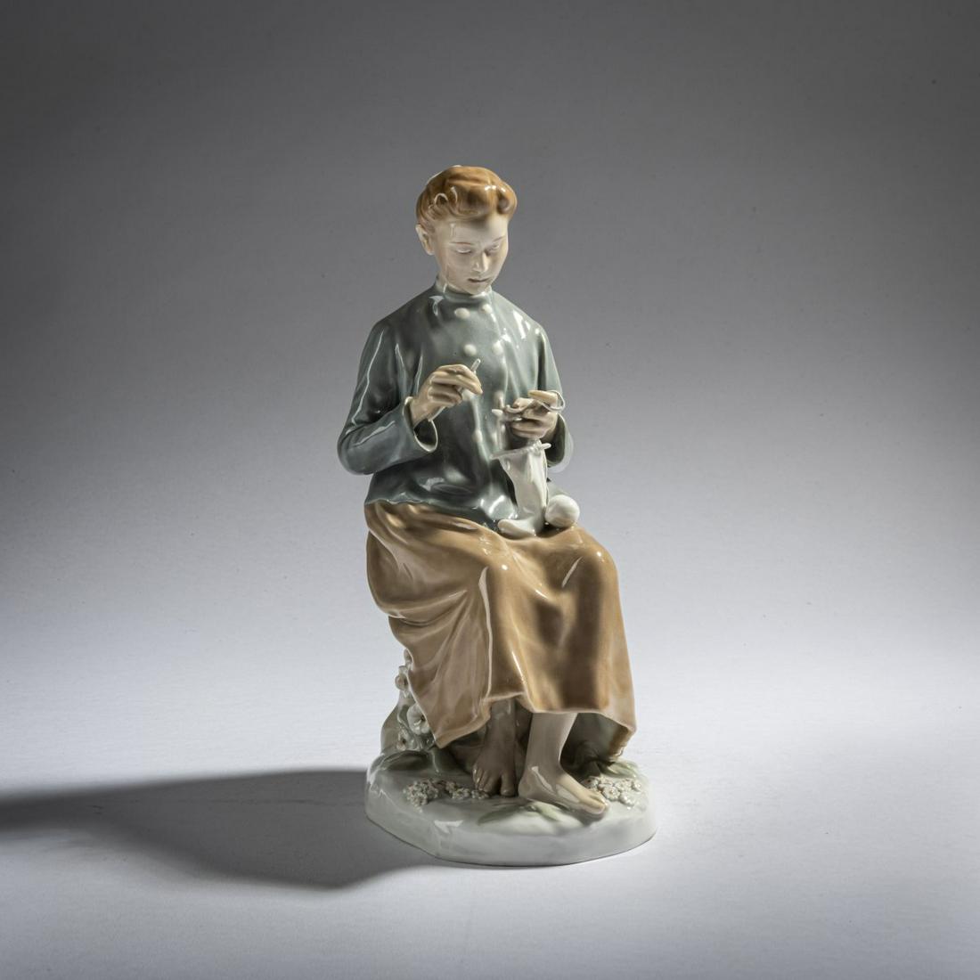 Theodor Eichler, 'Knitting girl', 1906: Theodor Eichler, 'Knitting girl', 1906, H. 23 cm. Execution: StPM Meissen, 1924-34. Porcelain, white, glazed, polychrome underglaze. Marked: Pfeiffer mark (blue, under glaze, four strokes), X 116 (inc
