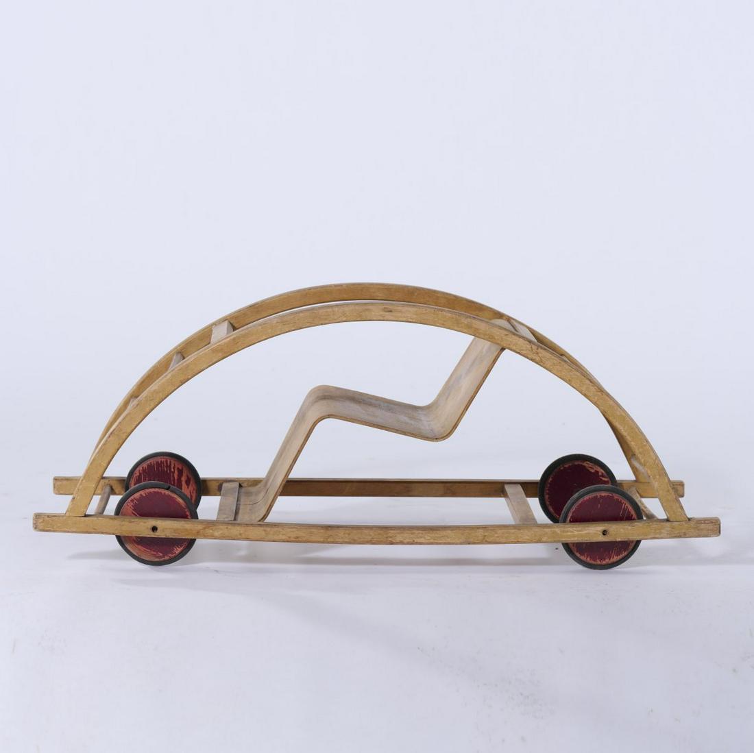 Hans Brockhage, Rocking wagon, 1951: Hans Brockhage, Rocking wagon, 1951, H. 39 x 98.5 x 38 cm. Made by Siegfried Lenz, Berggiesshuebel / Pirna. Beech wood and plywood, wheels painted red, rubber., Exh. cat. Fidgety Philip! A Design Hist