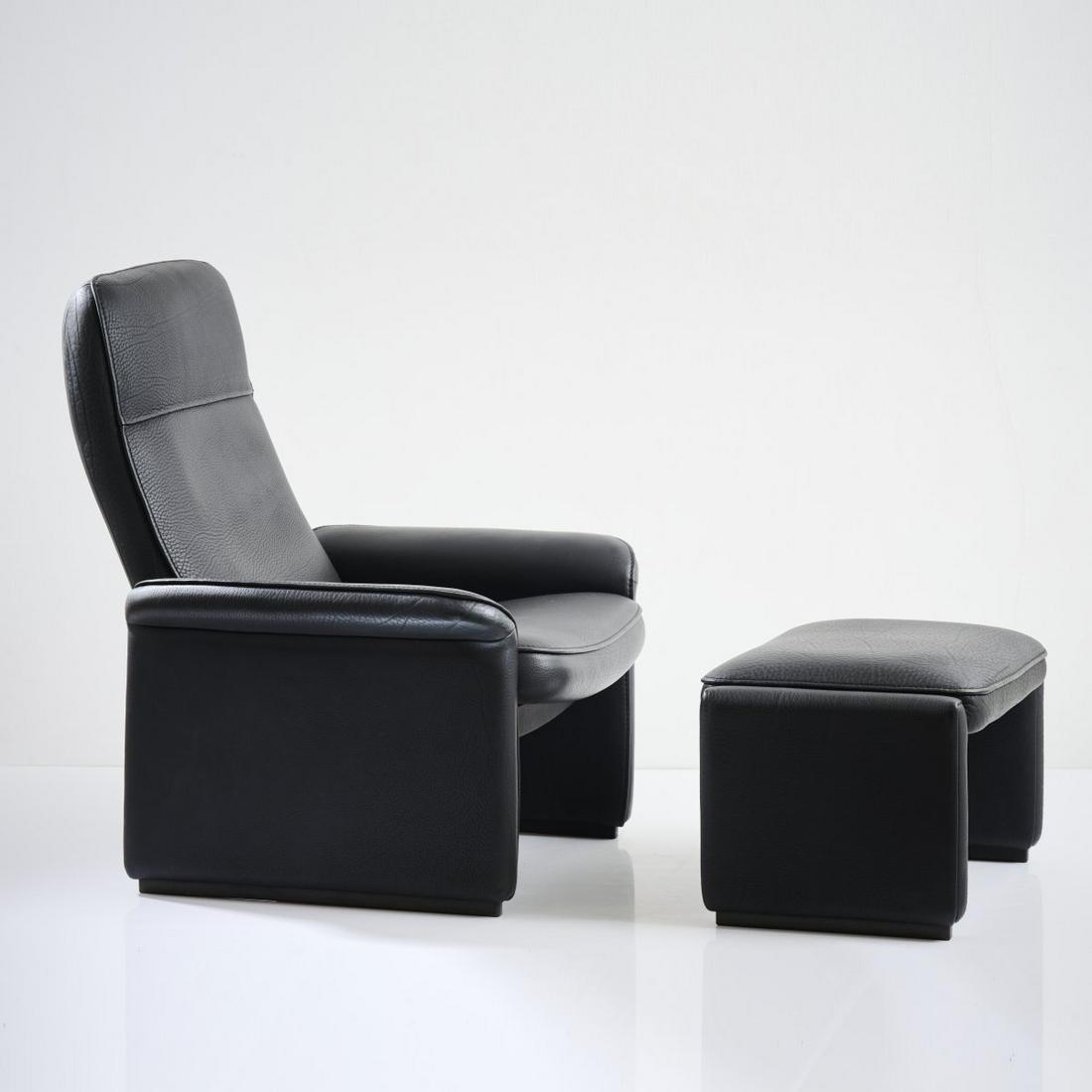 De Sede Design Team, 'DS50' armchair with ottoman, 1970s: De Sede Design Team, 'DS50' armchair with ottoman, 1970s, Armchair: H. 100 x 78 x 80 cm; Ottoman: H. 40 x 64 x 44 cm. Made by De Sede, Klingnau. Wooden construction, black leather. Marked: branded fab