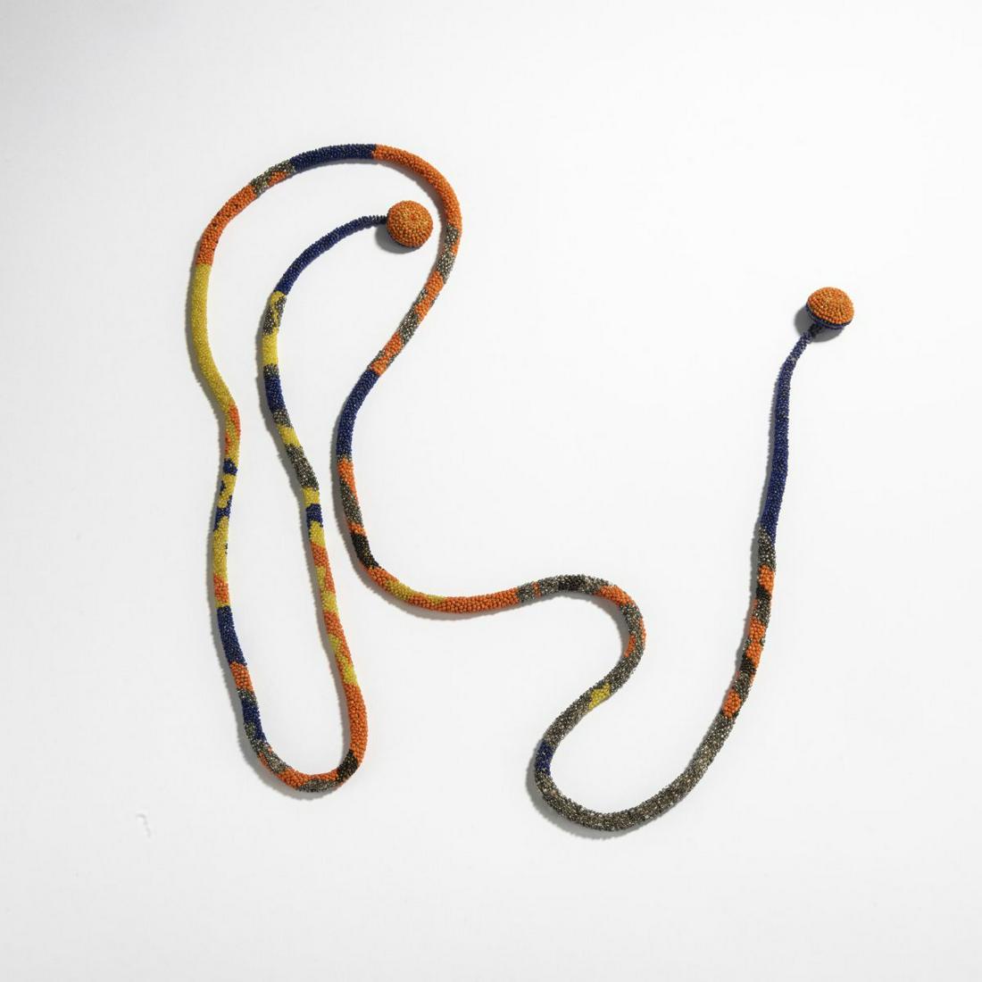 Maria Likarz , Necklace of glass beads, c. 1920: Maria Likarz , Necklace of glass beads, c. 1920, L. 129 cm. Made by Wiener Werkstätte. Glass beads, orange, silver, violet and yellow, threaded and braided, wooden knobs embroidered with beads.,