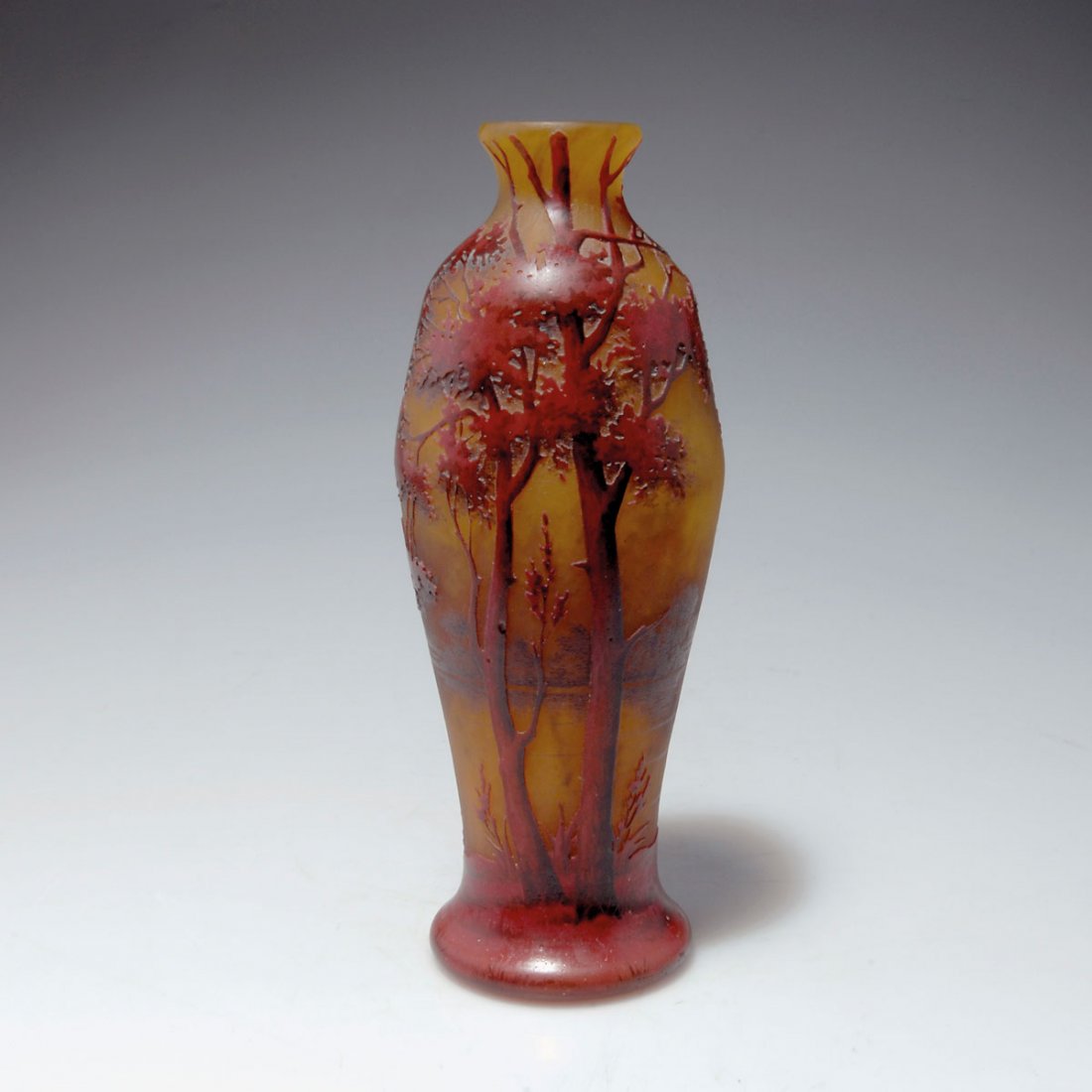 Vase 'Paysage lacustre', um 1905: Daum Frères, Nancy. 'Paysage lacustre' vase, c1905. H. 20.3 cm. Clear glass, orange powder inclusions, pink enamel fusions. Etched pattern with grisaille paint. Landscape with trees. Signed: DAUM NAN