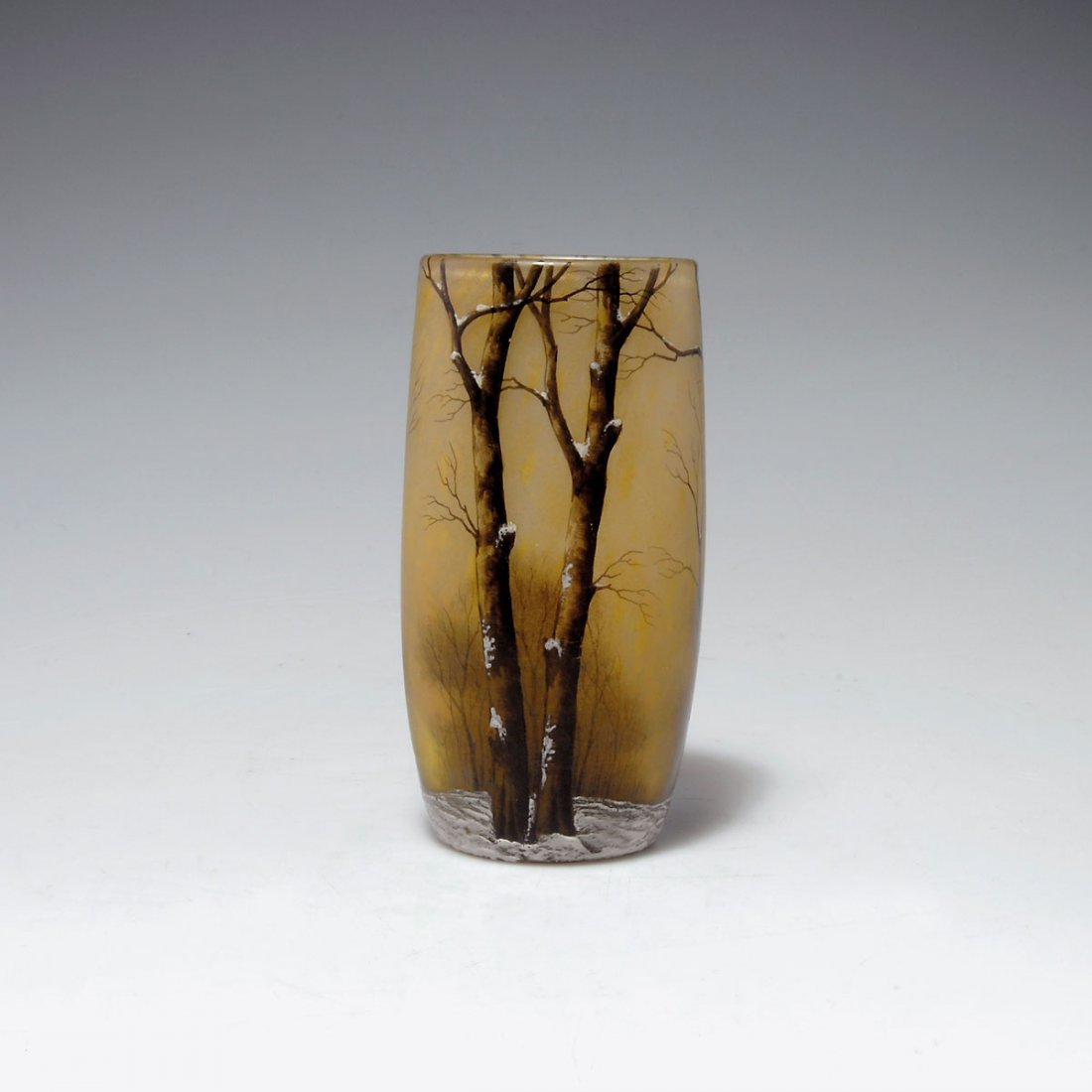Vase 'Arbres en hiver', um 1910: Daum Frères, Nancy. 'Arbres en hiver' vase, c1910. H. 12.5 cm. Cased glass, clear, yellow powder inclusions. Matted ground. Grisaille paint, white enamel. Winter landscape. Signed: DAUM NANCY, cross