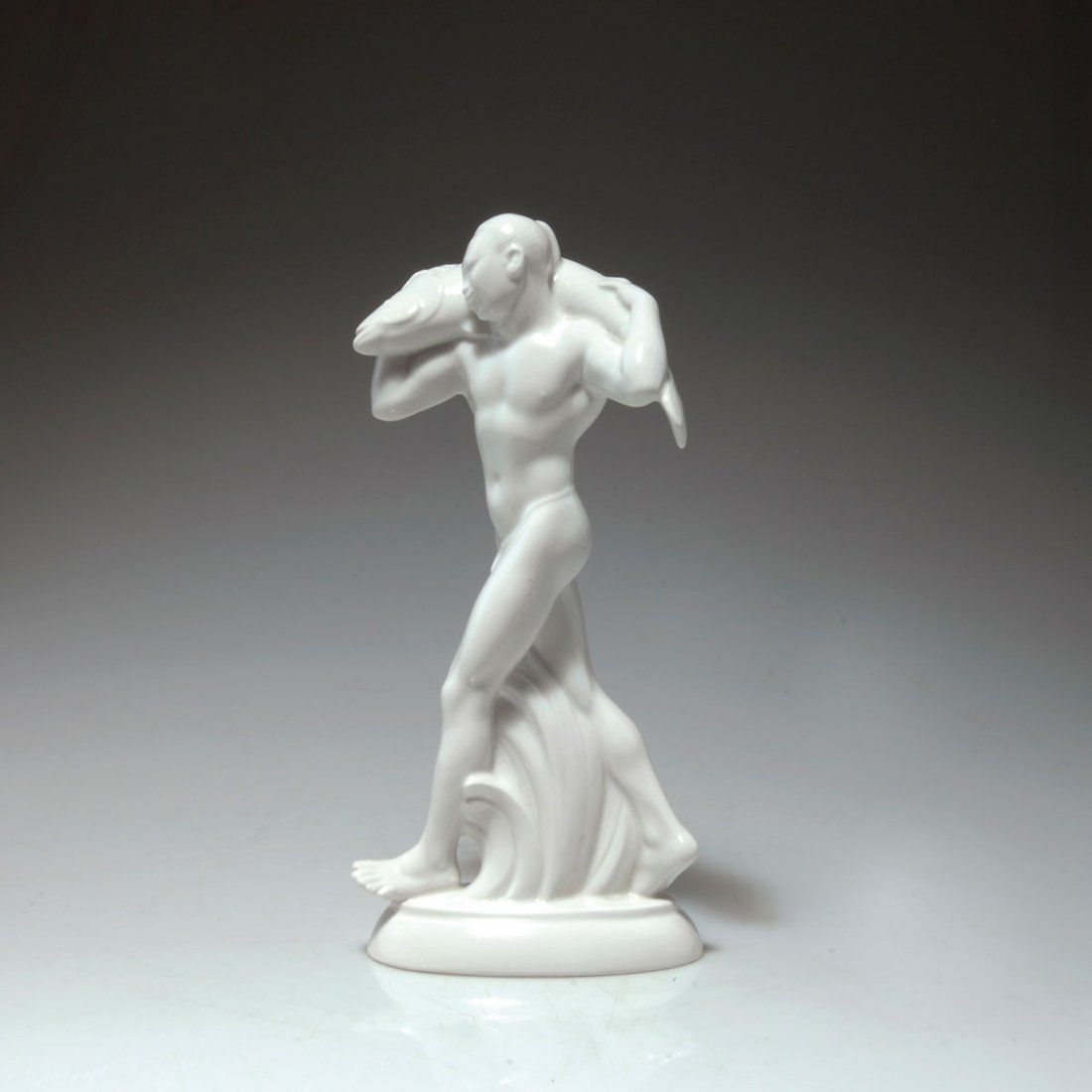 'Japaner mit Fisch' aus dem Hochzeitszug, 1910: StPM Berlin. 'Japanese man carrying a fish' from the 'Wedding parade', 1910. H. 27.3 cm. Designed by Adolph Amberg. Made in 1923. Porcelain, white, glazed. Base marked: AMBERG. Marked: Maker's mark, 9