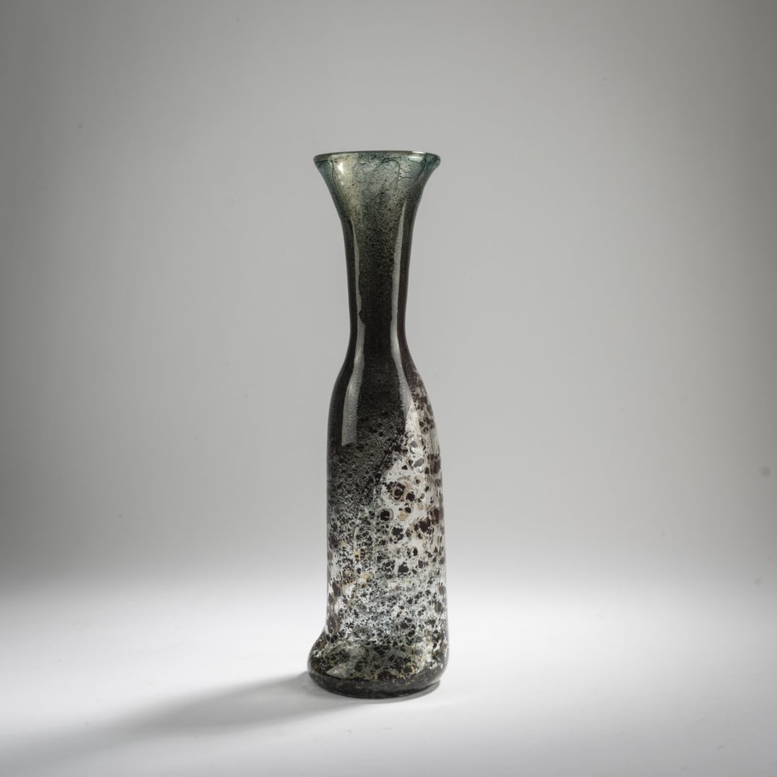 Ercole Barovier, 'Aborigeno' vase, 1954: H. 37 cm. Execution: Barovier & Toso. Cased glass, clear with crumbly oxide inclusions in wine-red and green-gray. Marked on the bottom: barovier & toso murano (engraved). Literature: Cf. Mari