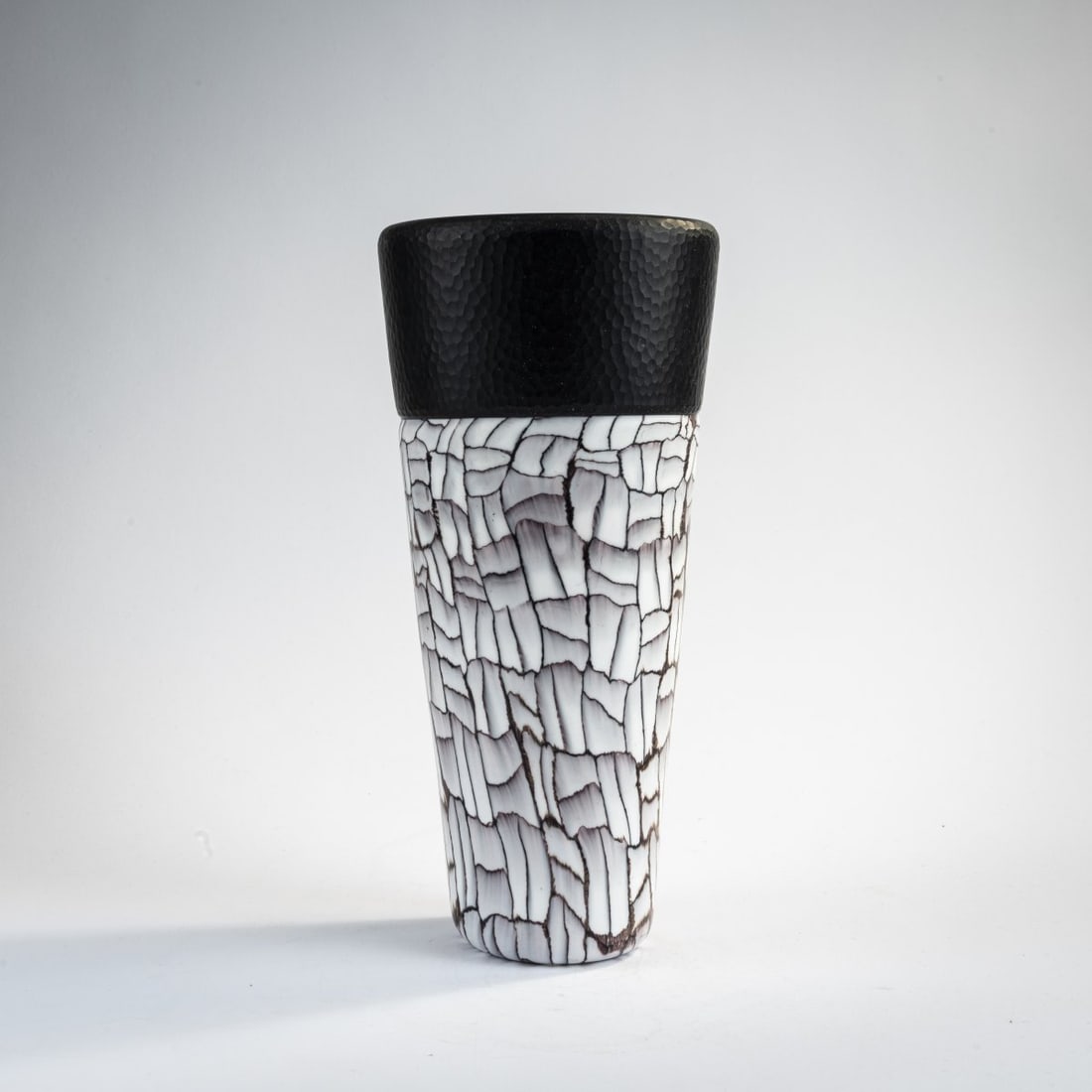 Vittorio Ferro, Vase, 2000: H. 28.2 cm. Cased glass, colorless and deep violet, platelets of opaque white and violet glass fused together, surface partially reworked with the wheel. Marked on the bottom: Vittorio Ferro 2000 (eng