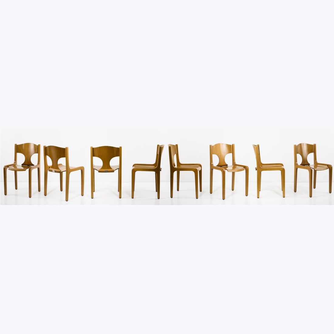 Augusto Savini, Eight chairs, 1968: H. 82 x 46.5 x 52.5 cm. Made by Pozzi, Mariano. Ash wood, plywood with ash veneer, metal clip. Marked: manufacturer's label. Literature: Domus 450, 1967, p. 31.