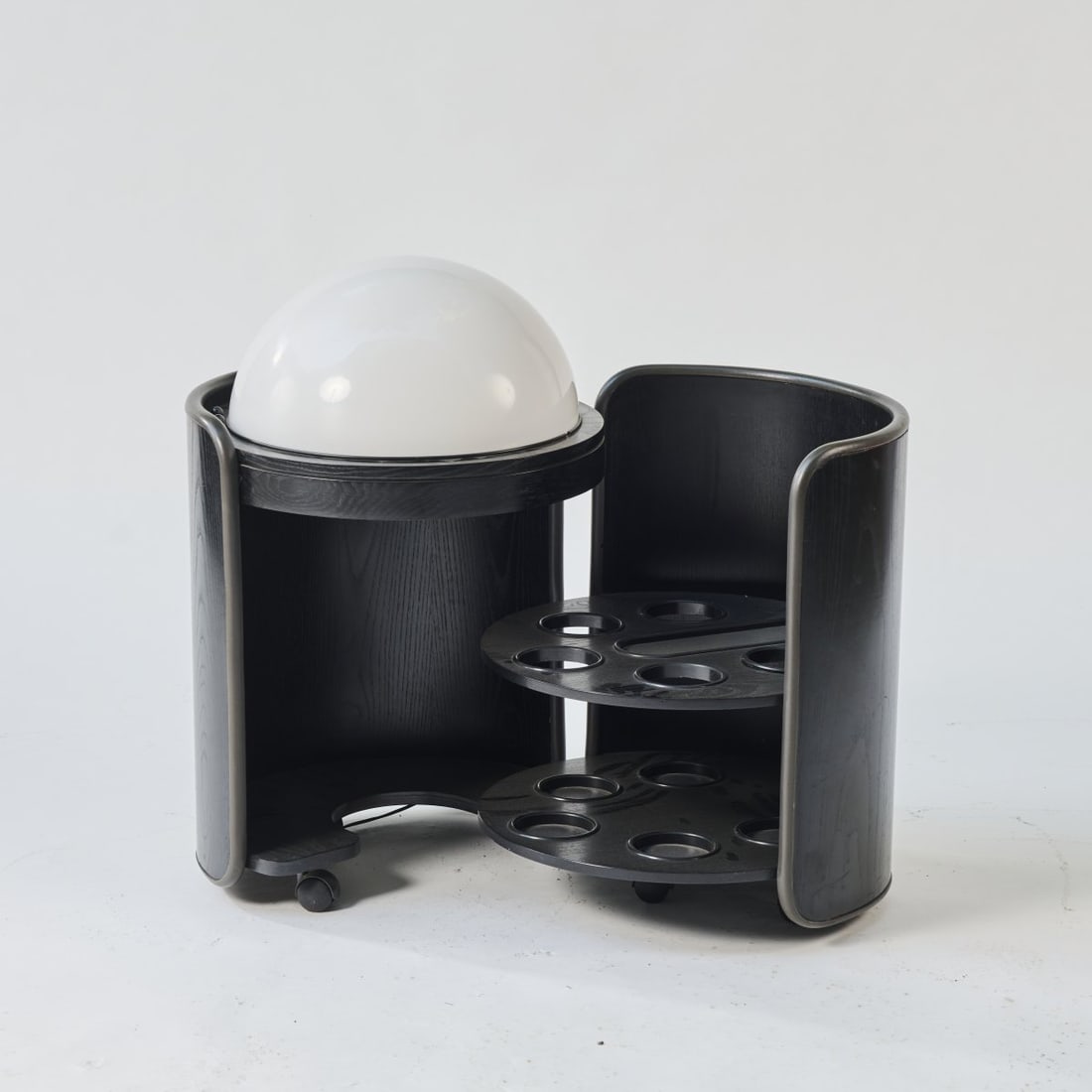 Luigi Massoni (STYLE), Bar on casters, c. 1968: H. 81 cm, Ø 54 cm. Wood, painted black, black and white plastic.