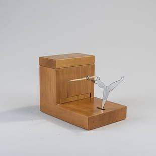 Andrea Branzi, Toothpick holder, 1991: H. 9.5 x 8.5 x 15 cm. Made by Alessi Tendentse, Milan. Pear wood, stainless steel. Marked: Manufacturer's stamp. Literature: Alessi, Die Traumfabrik, Milan 2001, p. 94.