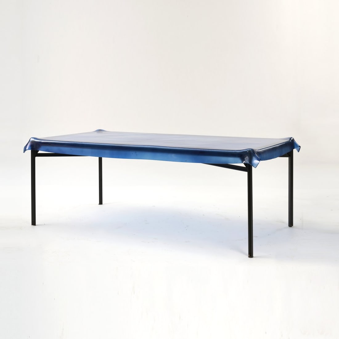 Philippe Starck, 'Illusion' table, 1992: H. 77 x 211.5 x 112 cm. Made by Fiam, Pesaro. Sectional metal, blackened, brass, glass, dark blue. Marked: stamp on three of four support points (legs): FIAM, STARCK, 33. Literature: Philippi, STARCK