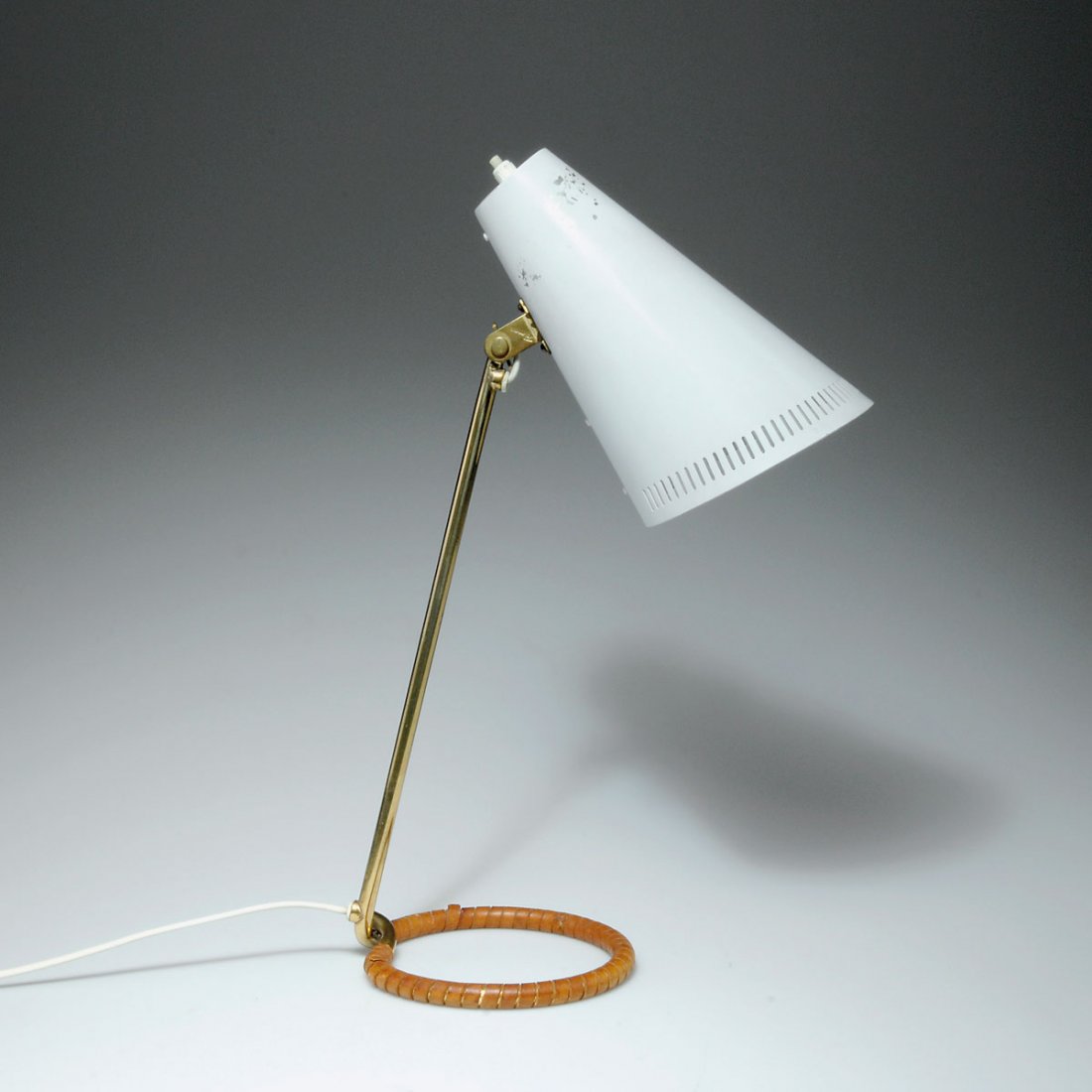Table light: Paavo Tynell. Table light, designed c1950. H. 45.5 cm. Made by Idman Oy, Helsinki. Brass tube, aluminium sheet, painted white, leather. Marked: Idman.