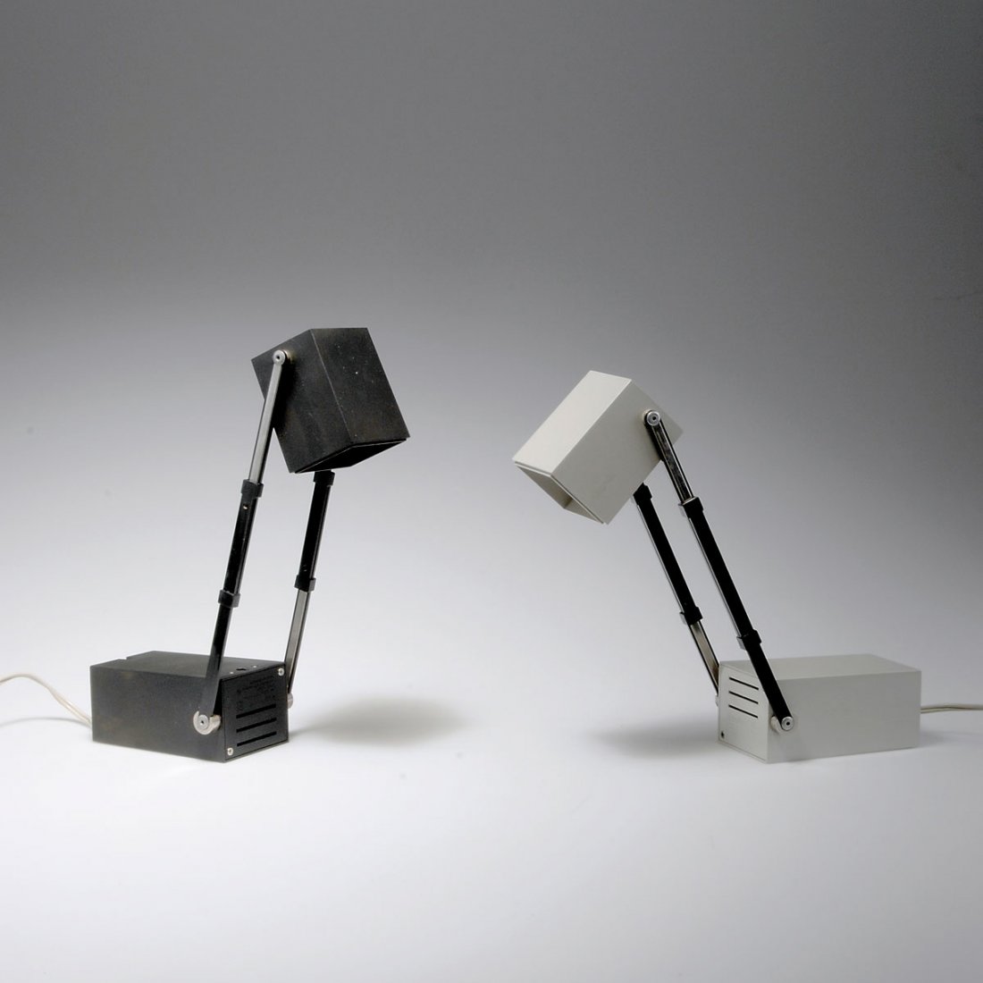 Verner Panton. Pair of 'LamPetit' table lights: Verner Panton. Pair of 'LamPetit' table lights, designed in 1966. H. 36 cm (max). Made by Louis Poulsen, Copenhagen. Grey and black plastic, metal rails. Marked: LamPetit, MADE IN DENMARK.