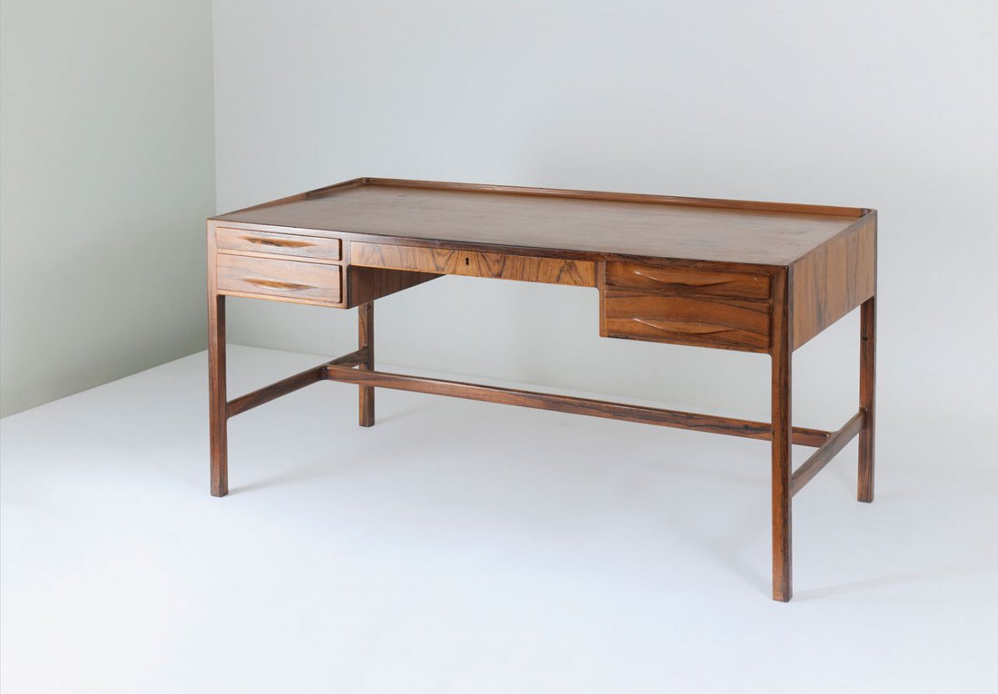 Kurt Oestervig. Writing desk: Kurt …stervig. Writing desk, designed c1957. H. 76 x 160 x 75 cm. Made by Jason Moebler, Ringstedt. Rosewood, rosewood veneer. Marked: Maker's label.