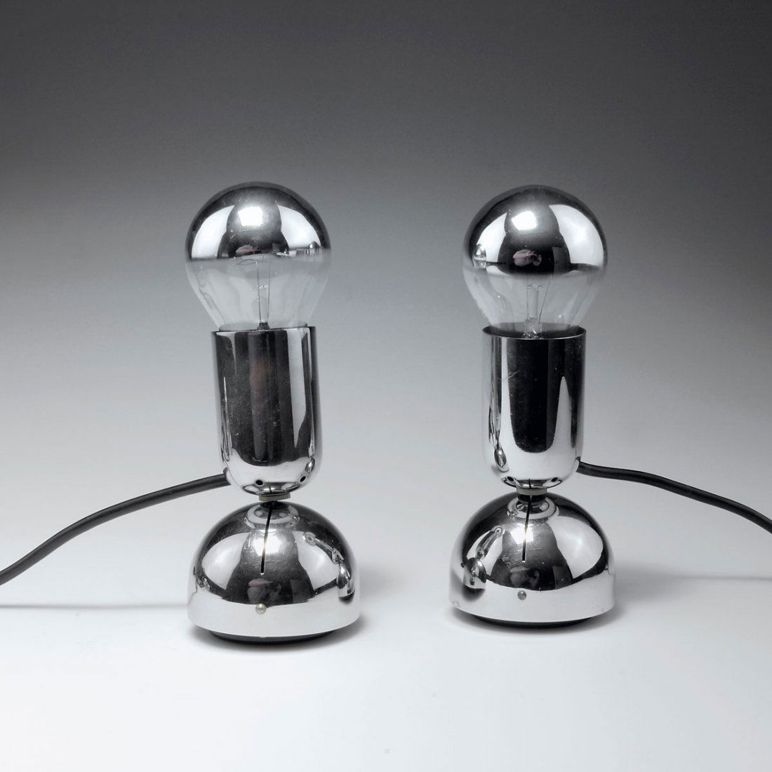 Ingo Maurer. Pair of 'Pollux' tablelights/sconces: Ingo Maurer. Pair of 'Pollux' tablelights/sconces, designed in 1967. H. 18.5 cm. Made by Design M Ingo Maurer, Munich. Chrome-plated metal, black plastic.
