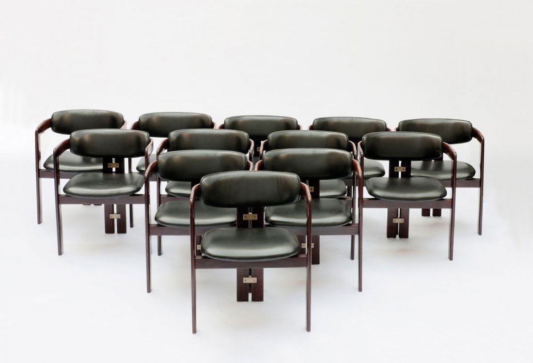 Auusto Savini. Twelve 'Pamplona' chairs: Augusto Savini. Twelve 'Pamplona' chairs, designed in 1965. H. 72.5 x 57.5 x 53.5 cm. Made by Pozzi, Mariano Comense. Ashwood, stained dark, clear lacquee, black leather, metal.