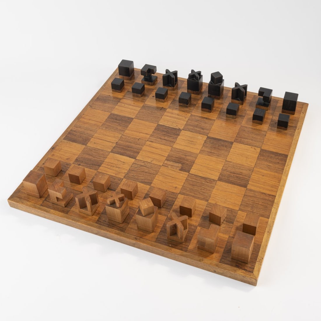 Josef Hartwig, Bauhaus chess set 'Model XIV', c. 1924: 32 figures. H. 2.3-5.6 cm. Made at Bauhaus, Weimar. Maple and walnut wood, partially painted black. Literature: Bauhaus-Archiv Berlin, Das Bauhaus-Schachspiel von Josef Hartwig, Berlin 2006, p. 18.
