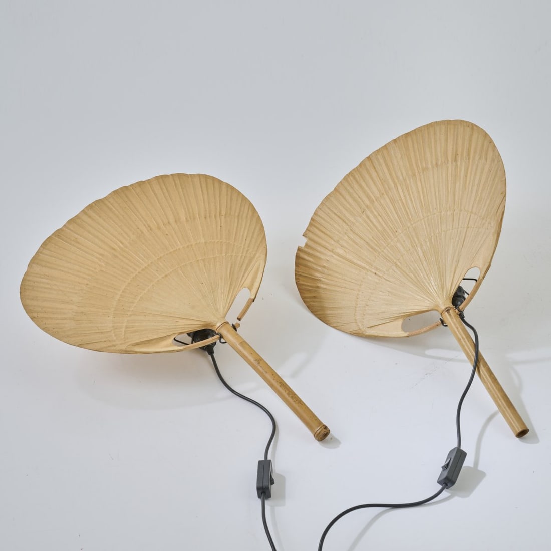 Ingo Maurer, Two wall lights 'Uchiwa IV', 1973: H. 62,5 cm. Made by Design M, Ingo Maurer, Munich. Bamboo cane, rice paper.