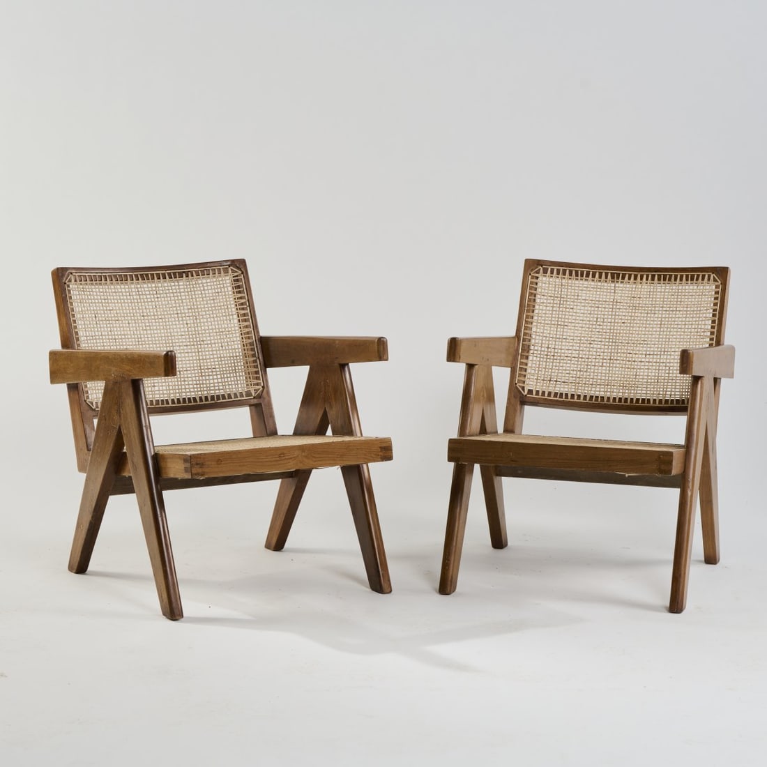 Pierre Jeanneret; Le Corbusier, Two armchairs 'Chandigarh' - 'PJ-SI-29-A', 1955/56: H. 66.5 x 52.5 x 73 cm. Made in Chandigarh, India. Teak, rattan weave. Marked: PSA/CH/227 - PSA/CH/226. Literature: Touchaleaume/Moreau, Le Corbusier Pierre Jeanneret, L'Aventure Indienne, Montreuil