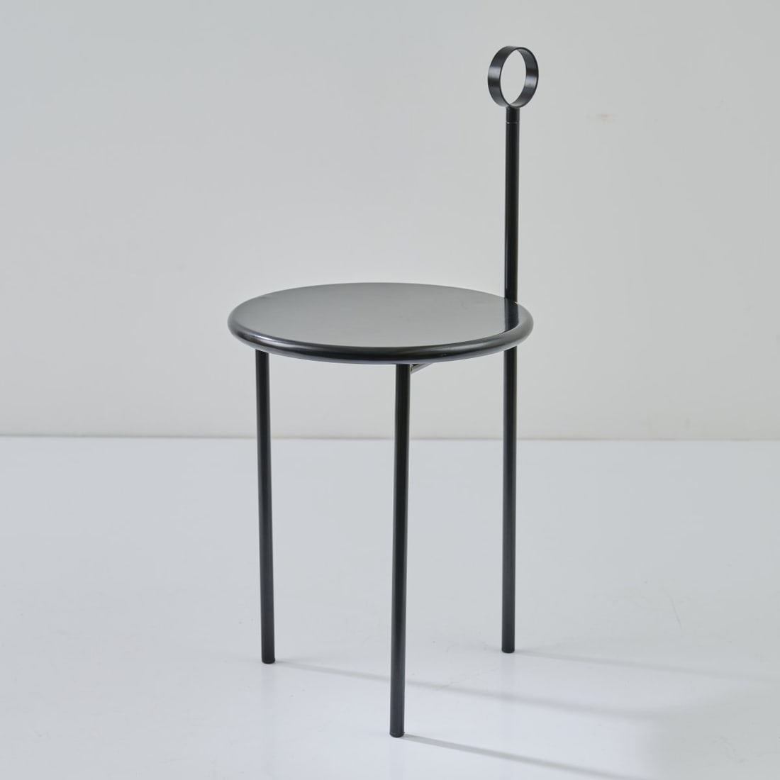 Philippe Starck, Chair/side table 'Mickville', 1985: H. 81 x 38 x 41 cm. Made by Driade Aleph, Milan. Tubular metal, sheet metal, painted black. Marked: AlephUbik (manufacturer's label).