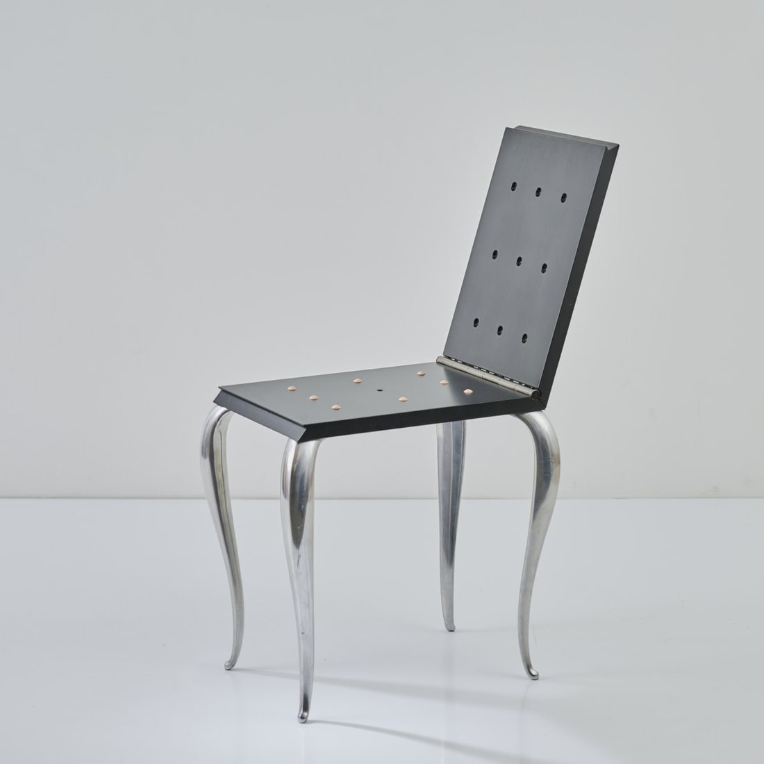 Philippe Starck, 'Lola Mundo' folding chair / stool, 1988: H. 48.5 x 34 x 60.5 cm. Unfolded: H. 84 cm. Made by Driade, Caorso. Ebonized ash wood, cast aluminum, rubber nails. Literature: Philippi, STARCK, Cologne 2000, p. 174 f.