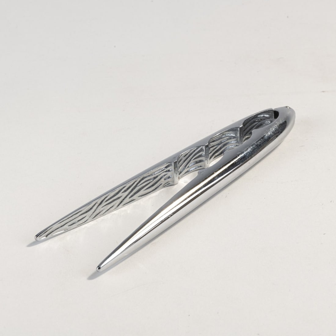 Philippe Starck, 'Casstoo' nutcracker from the 'Faitoo' series, 1990s: L. 19 cm. Made by Officina Alessi, Italy. Brass, chrome plated. Marked: manufacturer's mark, Starck.