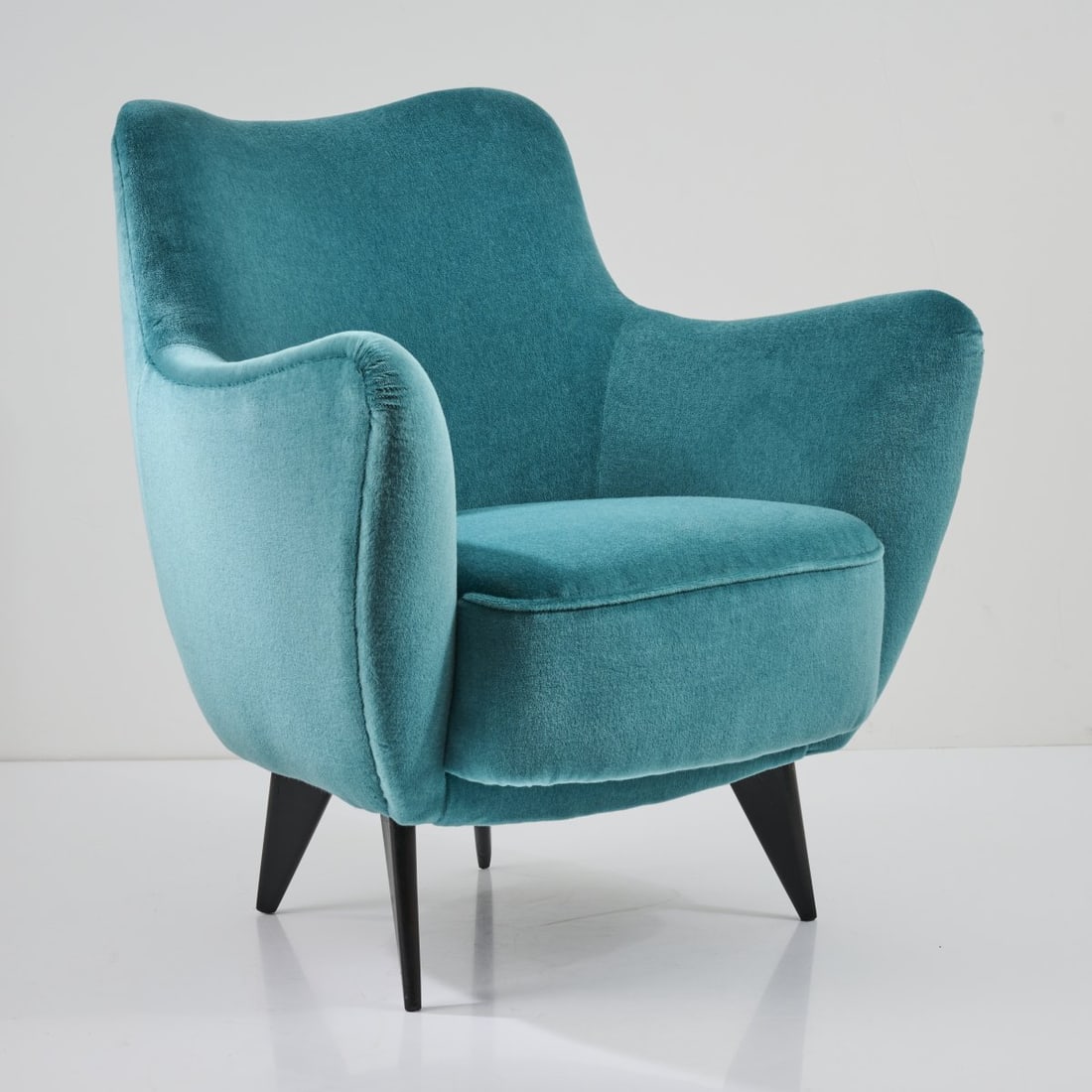 Giulia Veronesi, Armchair 'Perla', c. 1952: H. 87 x 77x 81 cm. Made by Isa, Bergamo. Beech wood, stained black, turquoise textile cover.