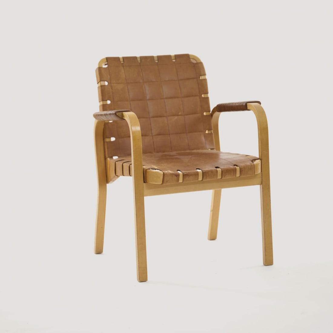 Alvar Aalto, Armchair '45', c. 1946: H. 80 x 56 x 57.5 cm. Made by Artek, Helsinki. Birch wood, birch plywood, cognac-colored leather. Literature: Kellein, Alvar & Aino Aalto. design, Ostfildern 2005, p. 146 f.