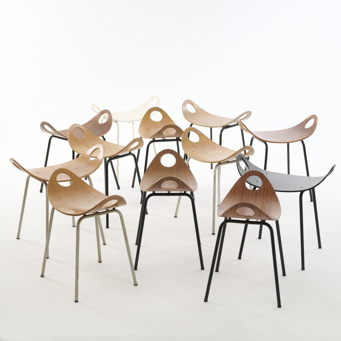 Olavi Kettunen, Twelve stools 'Ulla' 1955: H. 53 x 52-54 x 30 cm. Made by Merivaara Oy, Helsinki. Plywood, tubular metal, lacquered white and black. Marked: manufacturer's sticker.
