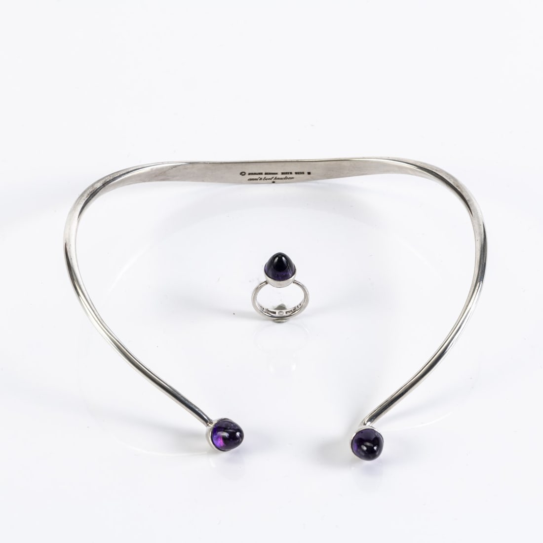 Bent Knudsen; Anni Knudsen, Necklace '5' and ring '1', 1960s: Sterling silver, amethyst. Necklace 85.63 grams. Ø 115-120 mm; Ring 6.18 grams. Thru 54.5. Marked: Manufacturer's mark ©, 925S, STERLING DENMARK, anni & bent knudsen, model no. (emboss