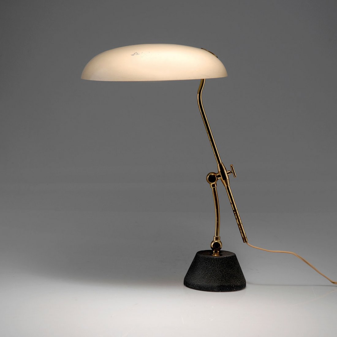 Table light, c1955: Arredoluce, Monza. Table light, c1955. H. 50 cm (max.), D. 30 cm. Sheet metal, painted creme-white, brass tube, cast iron, black lacquer.