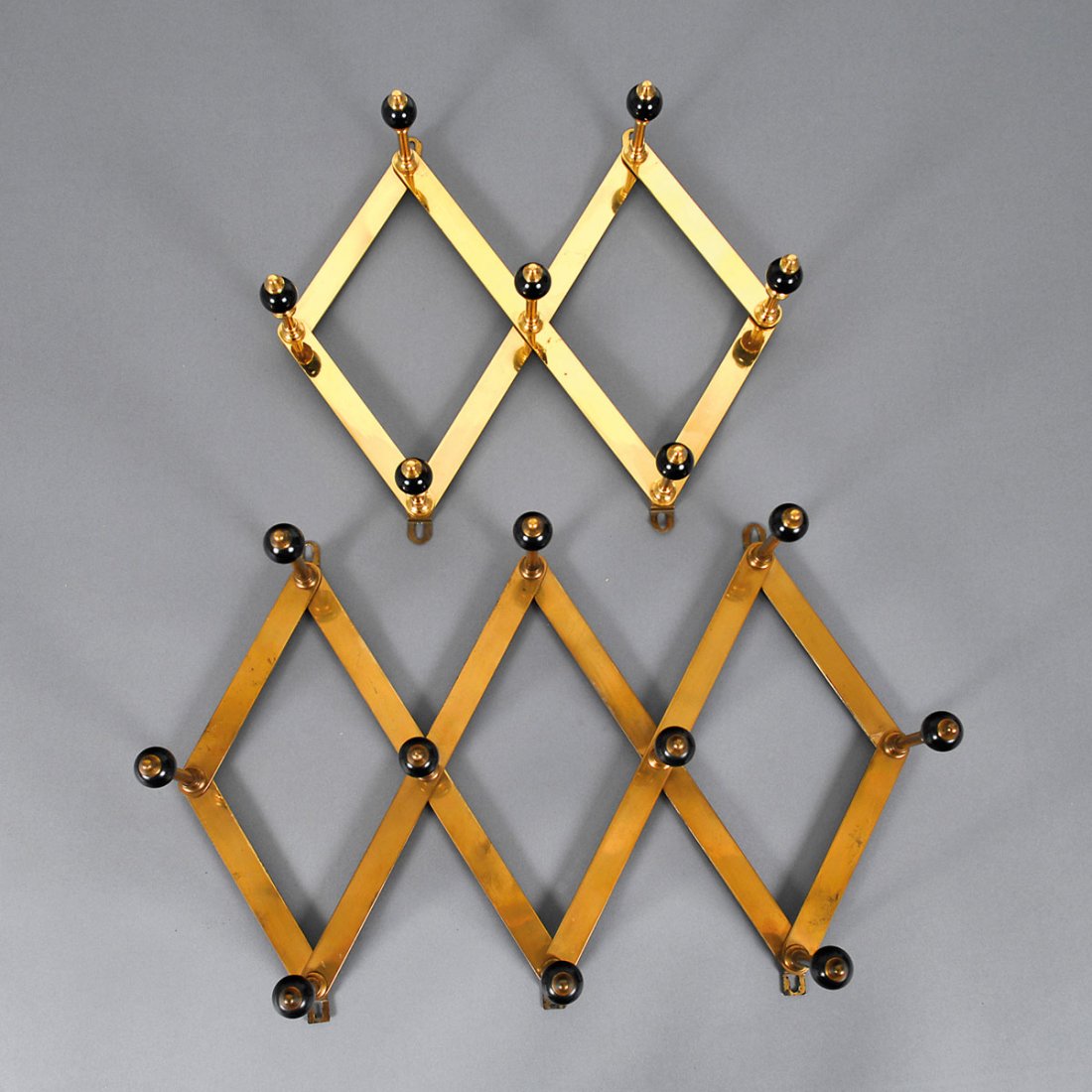 Coat rack for wall fastening, c1961: Luigi Caccia Dominioni. Coat rack, c1961. Two pieces. H. 29 x 62-82 x 13.5-16.5 cm. Made by Azucena, Milan. Brass, brass tube, wooden balls, painted black.
