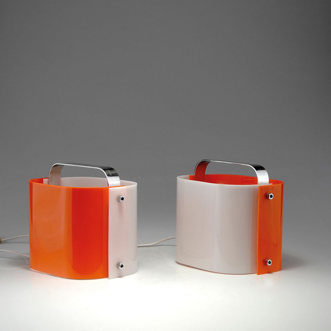 Pair of 'Polsino' table lights, 1968: Gio Ponti. Pair of 'Polsino' table lights, 1968. H. 22 x 24 x 17.5 cm. Made by Guzzini, Milan. Chrome-plated metal, perspex, white and orange.