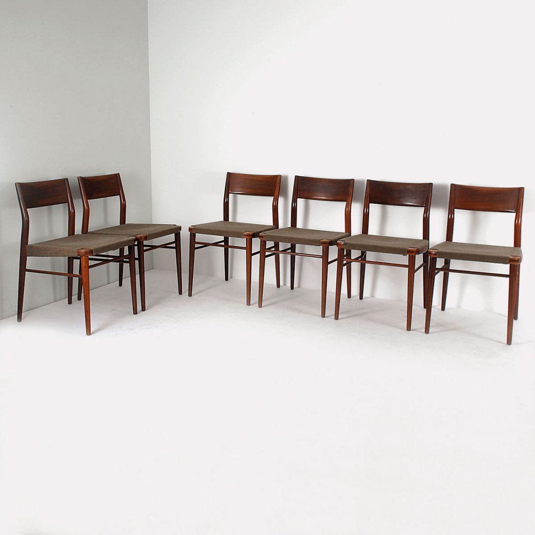 Six chairs, 1954: Georg Leowald. Six chairs, 1954. H. 77 x 47 x 54 cm. Made by Wilkhahn, Eimbeckhausen. Teak, fabric. Marked: Maker's label.