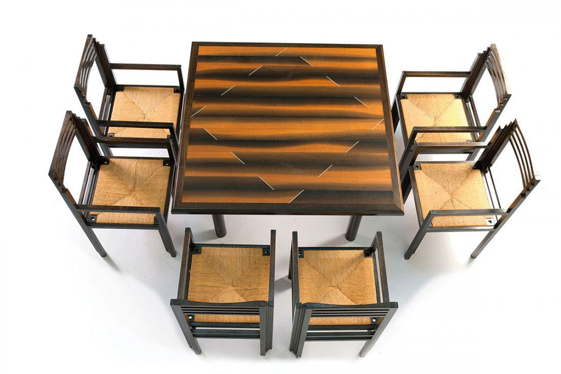 Dining table and six chairs, c1986: Studio Hans Hollein; Beate Kugel. Dining table and six chairs, c1986. Dining table: H. 75 x 127 x 127 cm; chairs: H. 95.5 x 48.5 x 52 cm. Table top of moor oak, aluminium, legs of black tubular steel,