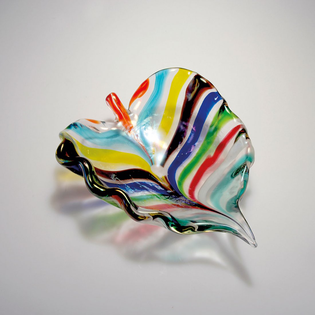 'Foglia a colore' bowl: Giorgio Ferro (attributed). 'Foglia a colore' bowl. Designed in 1952-55. 35.5 x 29 cm. Made by A.Ve.M. Cased glass, clear, strongly iridescent, multicoloured stripes.
