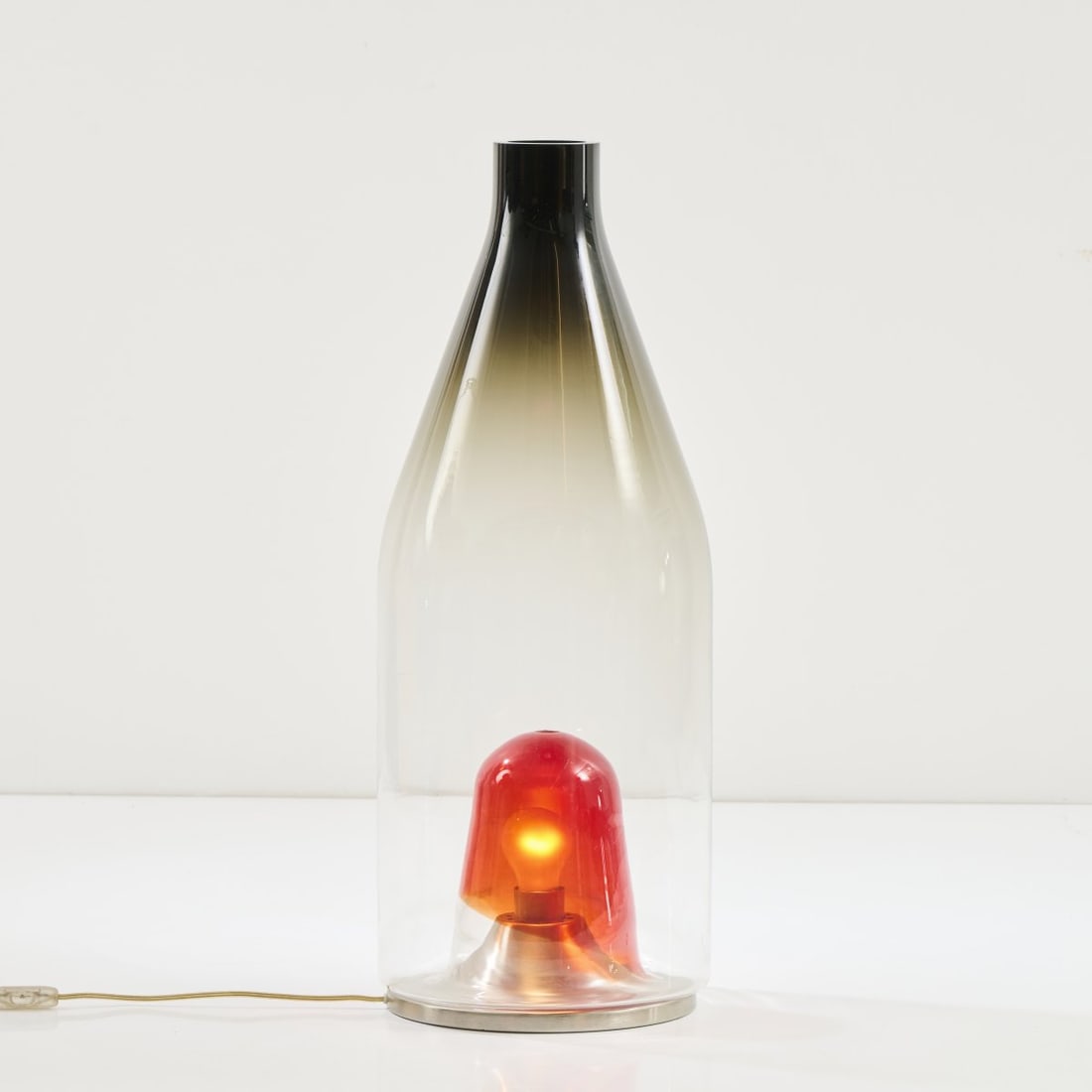 Thomas Sandell, Table / floor light, 1990s: H. 72.5 cm, Ø 29 cm. Made by Leucos, Milan. Glass, clear, smoke gray and red, sheet metal. Marked: manufacturer sticker.