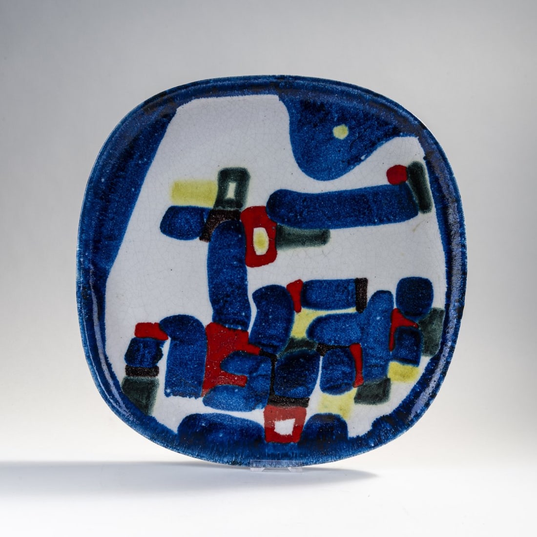 Guido Gambone, Decorative plate, c. 1955: 41.2 x 40.8 cm. Earthenware, polychrome glaze on white. Marked: donkey mark, GAMBONE ITALY (brown, handwritten).