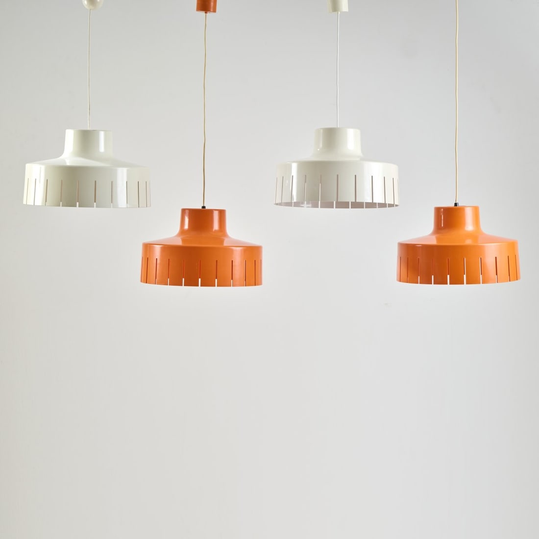 Sergio Asti, Four 'Frangia' ceiling lights, 1979: H. 27 cm (without suspension), Ø 40 cm. Made by Bilumen, Milan. Plastic, white and orange. Marked: BILUMEN Art. design Sergio Asti made in Italy.