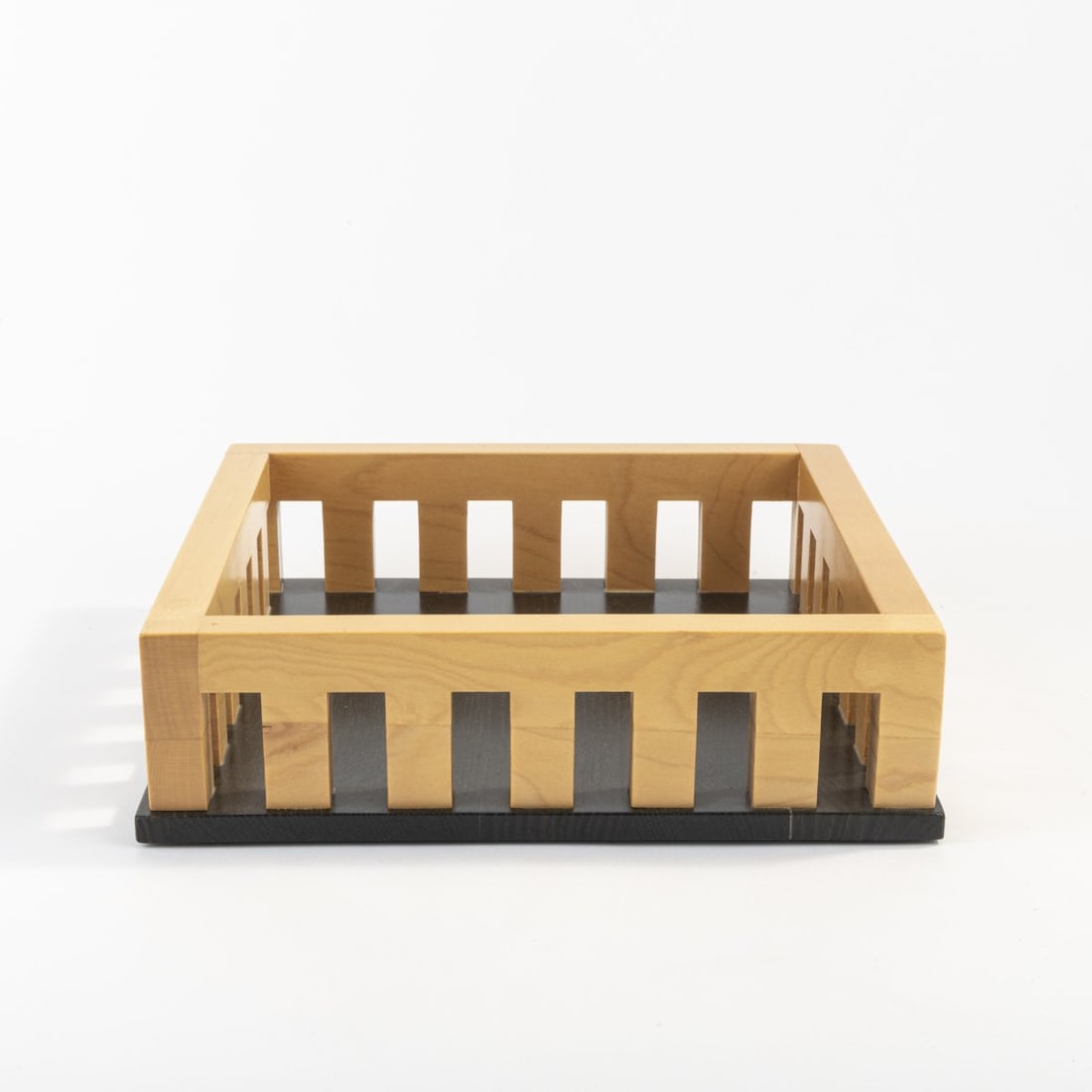 Adalberto Pironi, Storage basket 'CT 326', 1990: H. 7.5 x 26 x 26 cm. Made by Alessi Twergi, Crusinallo. Wood, partly stained black. Marked: manufacturer's mark.