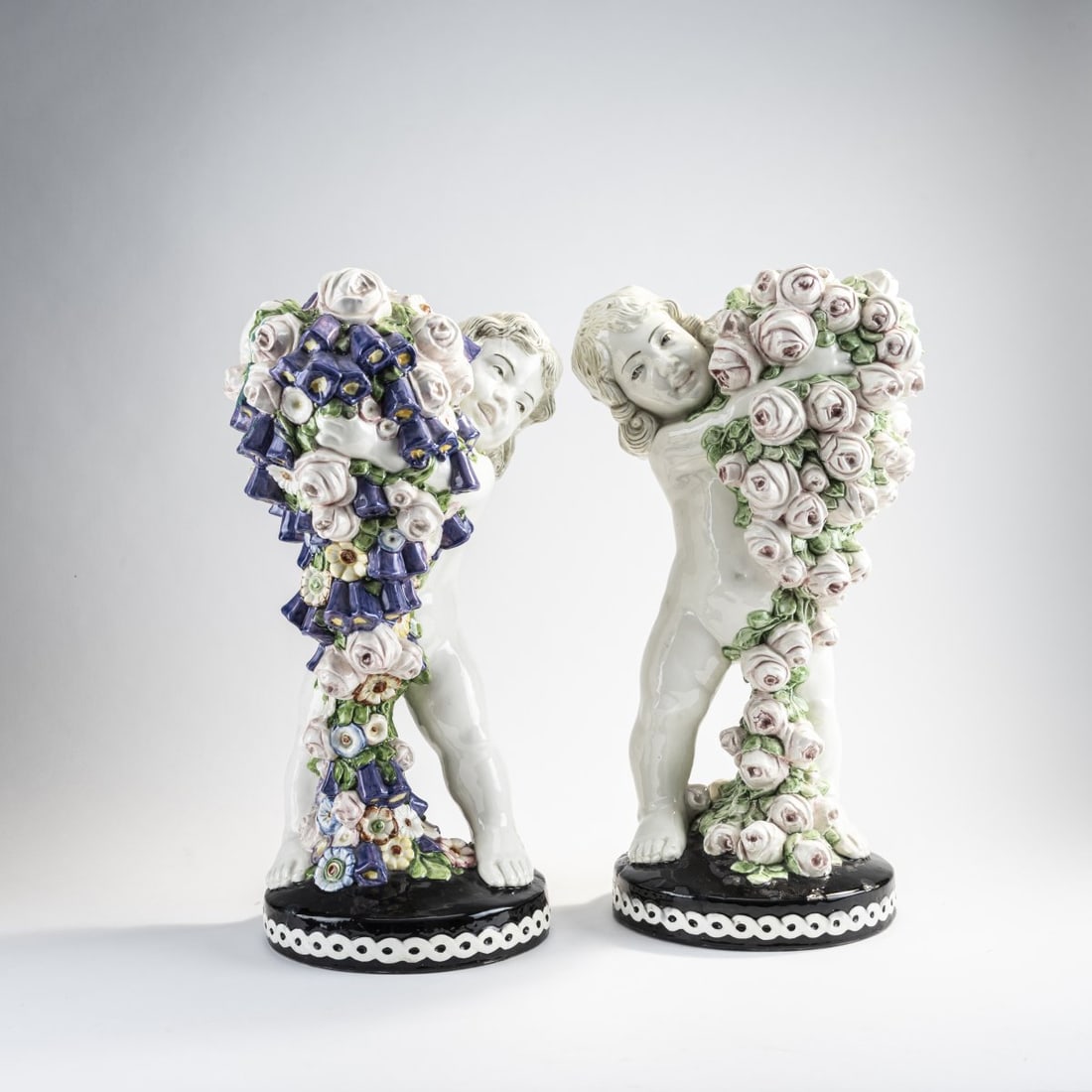 Carl Klimt, Two flower putti, c. 1910: H. 48.7 cm. Execution: Bernhard Bloch, Eichwald. Faience, polychrome glaze. Bottom marked: manufacturer's mark 1194 (black) 9388 45 10 or 9389 (embossed). Literature: Neuwirth, Keramik von C. Klimt u