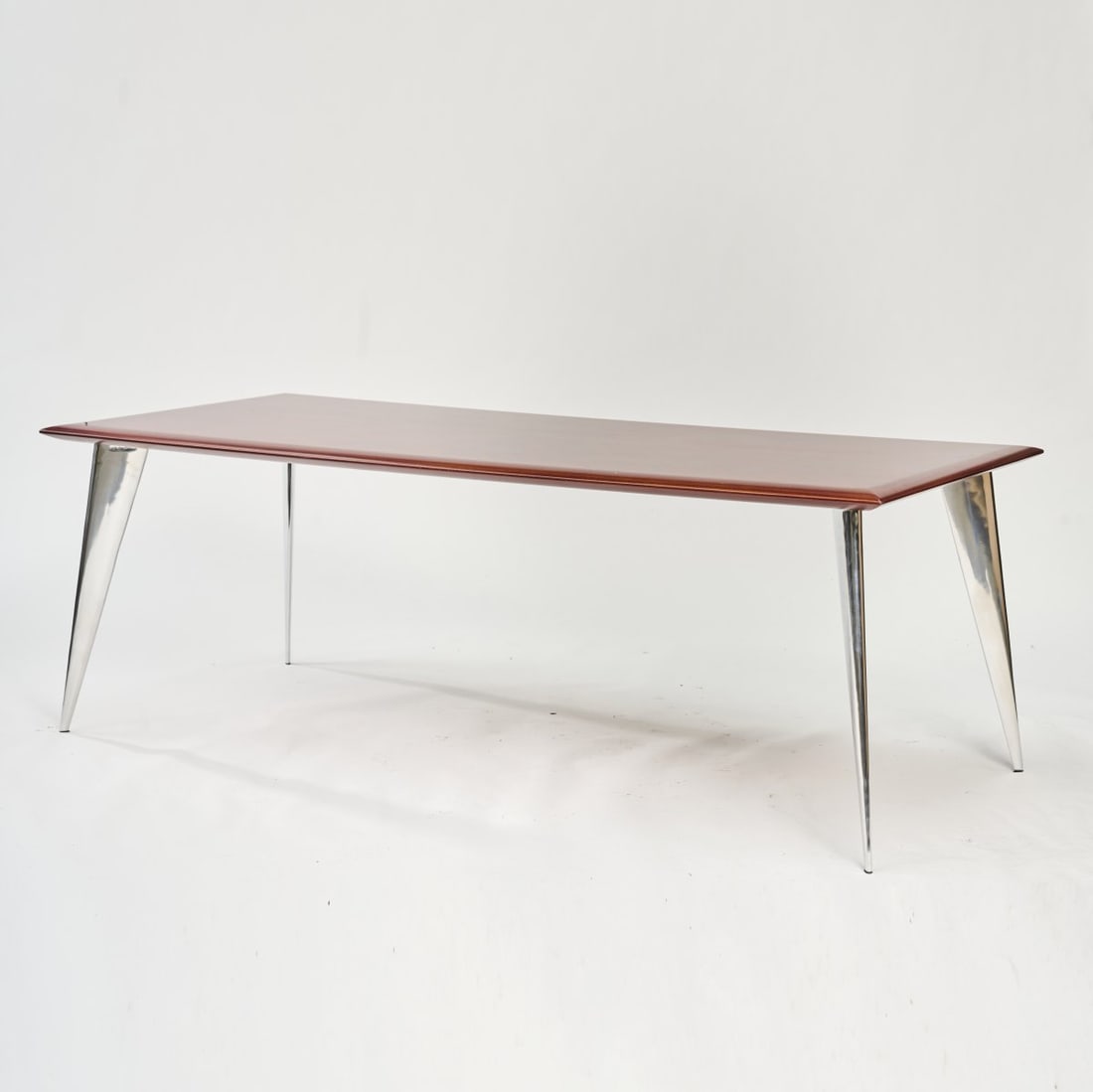 Philippe Starck, 'J. (Série Lang)' table, 1991: H. 74 x 210 x 90 cm. Made by Driade Aleph, Milan. Blockboard with mahogany veneer, cast aluminum, polished. Marked: ALEPH by Starck. Literature: Philippi, Starck, Cologne 2015, p. 182.