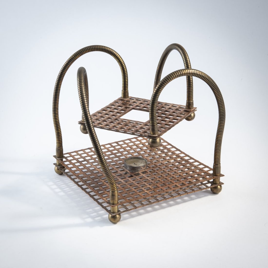 Stiletto; Frank Schreiner, Teapot warmer 'Teeträger', 1988: H. 26 x 21.5 x 21.5 cm. Made by Stiletto Studios, Berlin. Brass goosenecks, copper sheet, candle. Marked: "Teeträger" #13 Stiletto Studios 8/12/88 (engraved).